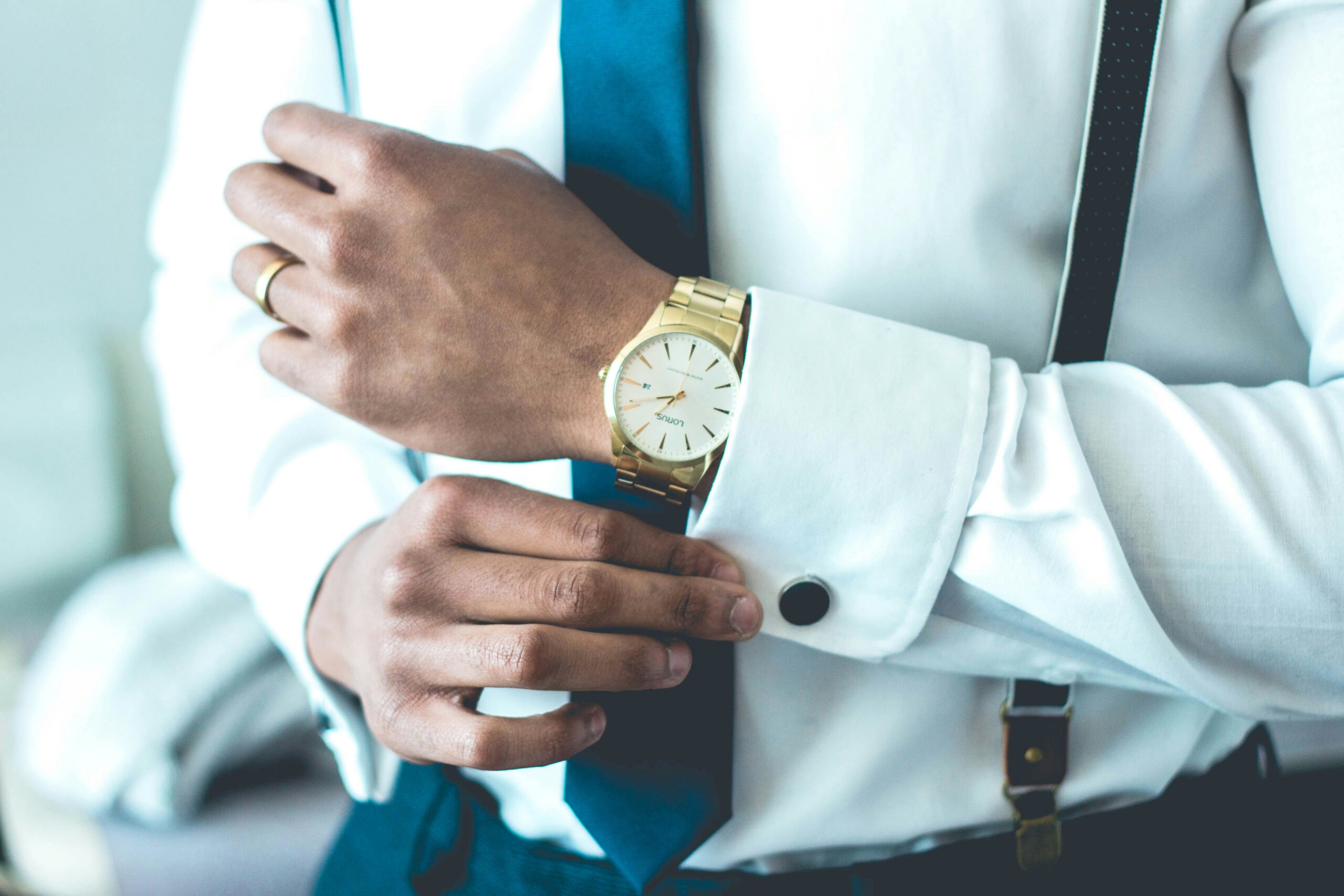 Mann mit Anzug und goldener Uhr